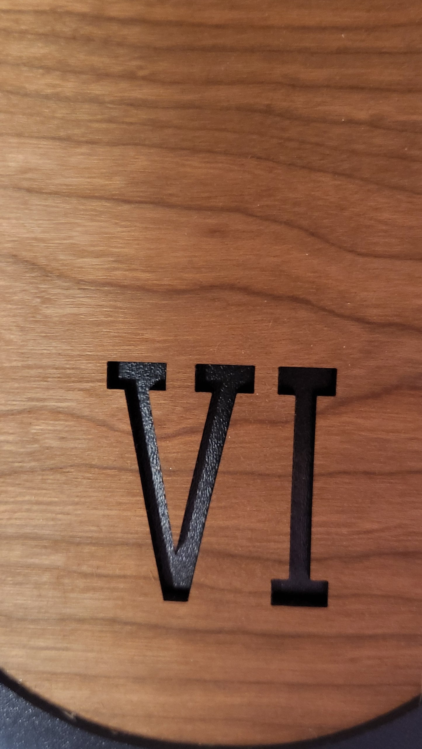 A detailed shot of the craftsmanship, showing the precise carving and natural grain patterns of the cherry wood.