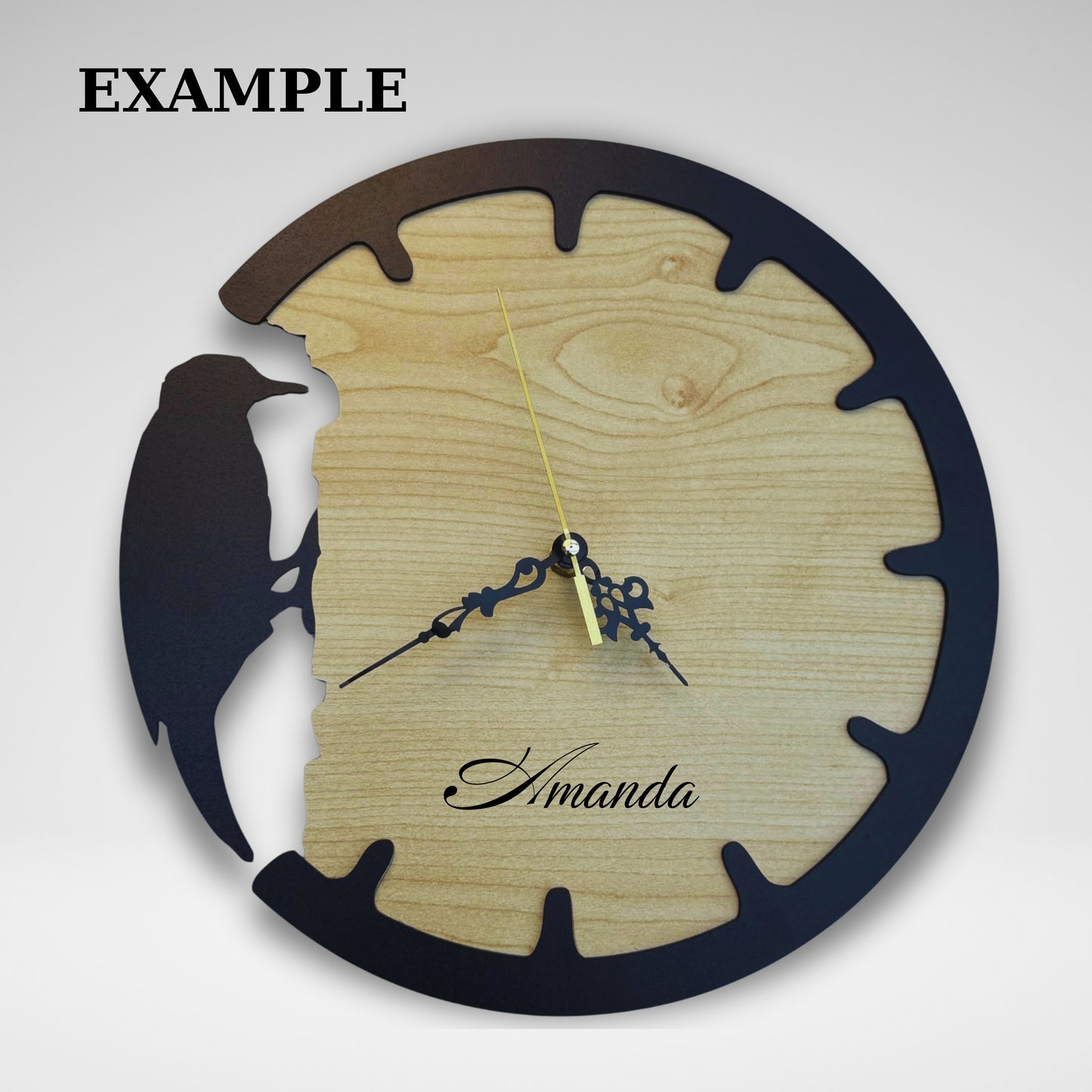 Wooden wall clock with bird design and 'Amanda' branding on a white background