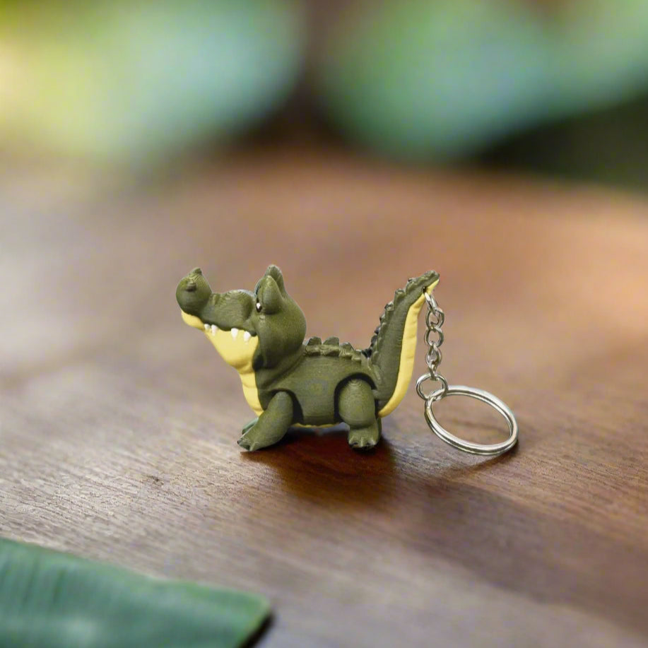Green dinosaur-shaped keychain on a white background