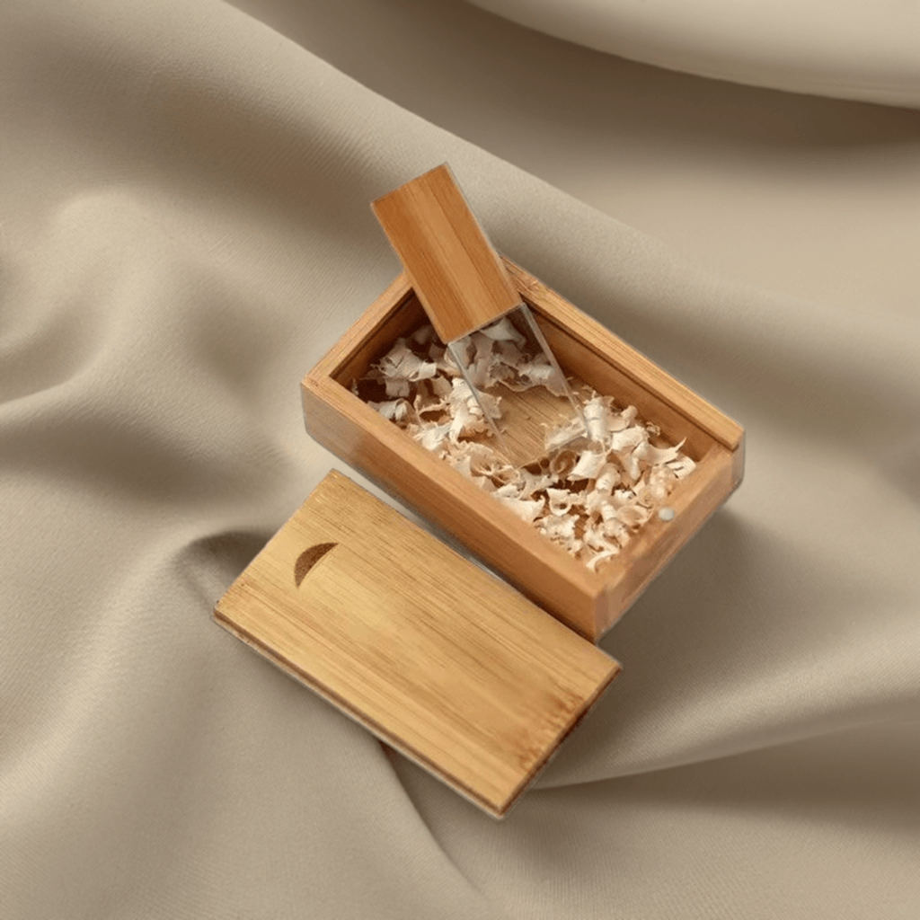 The USB drive resting on a soft fabric background, emphasising its premium materials and smooth finish.
