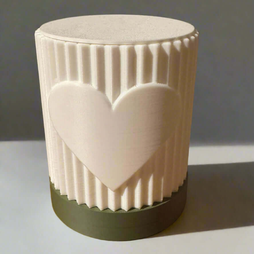 White ceramic mug with a heart design on a wooden surface