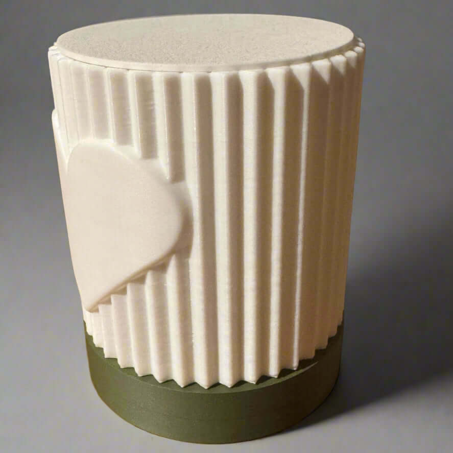 White textured lamp with green base on a wooden surface