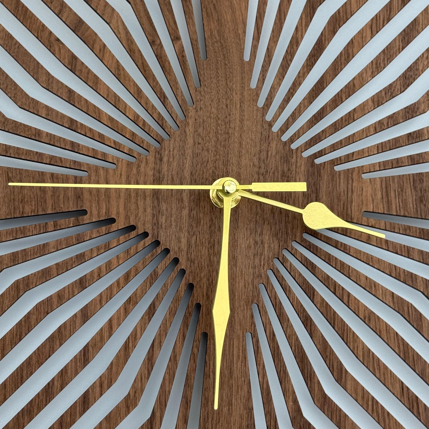 Wooden wall clock with geometric design and gold hands