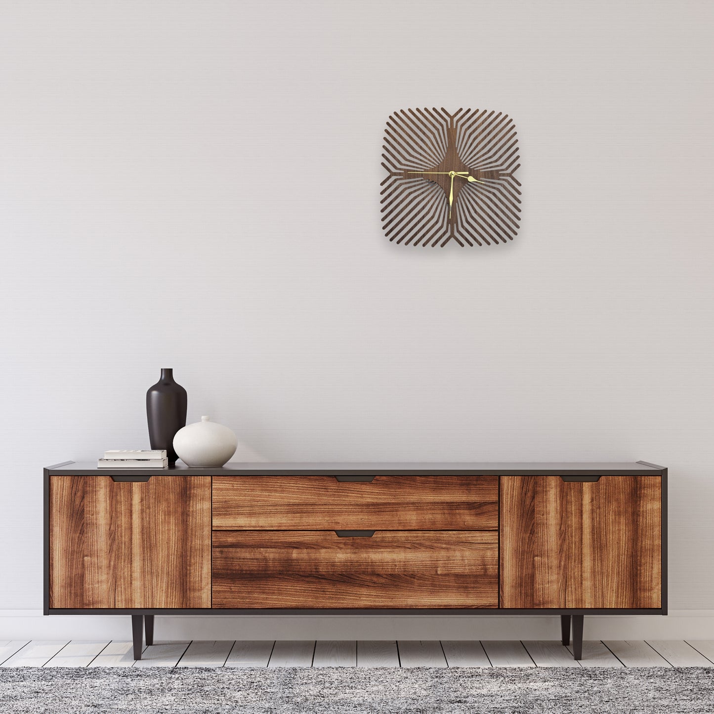 Wooden sideboard with decorative wall clock in a minimalistic room.