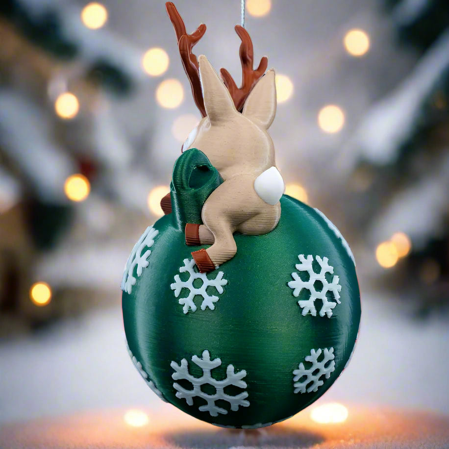 Side view of Lying Reindeer ornament hanging on a Christmas tree