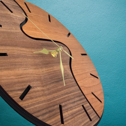 Wooden clock with gold hands on a blue background