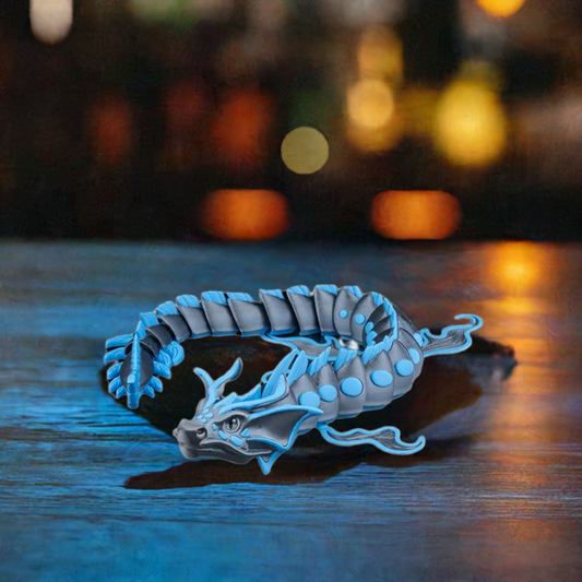 A 3D-printed Abyssal Dragon figurine in striking blue and grey, posed dynamically with a flowing body and articulated parts for lifelike movement.