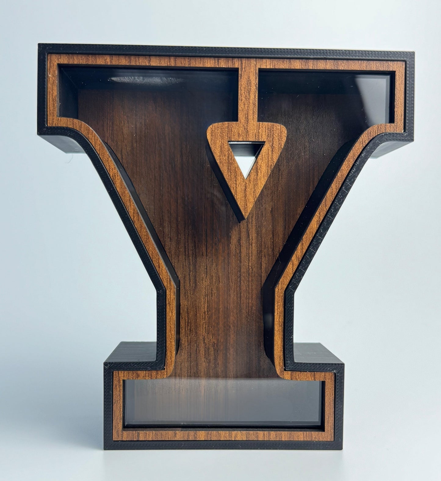 Wooden letter 'Y' with a geometric design on a light gray background