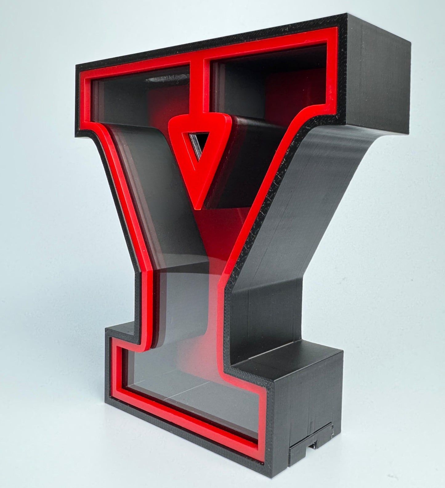 Black and red letter 'Y' shaped object on a light gray background