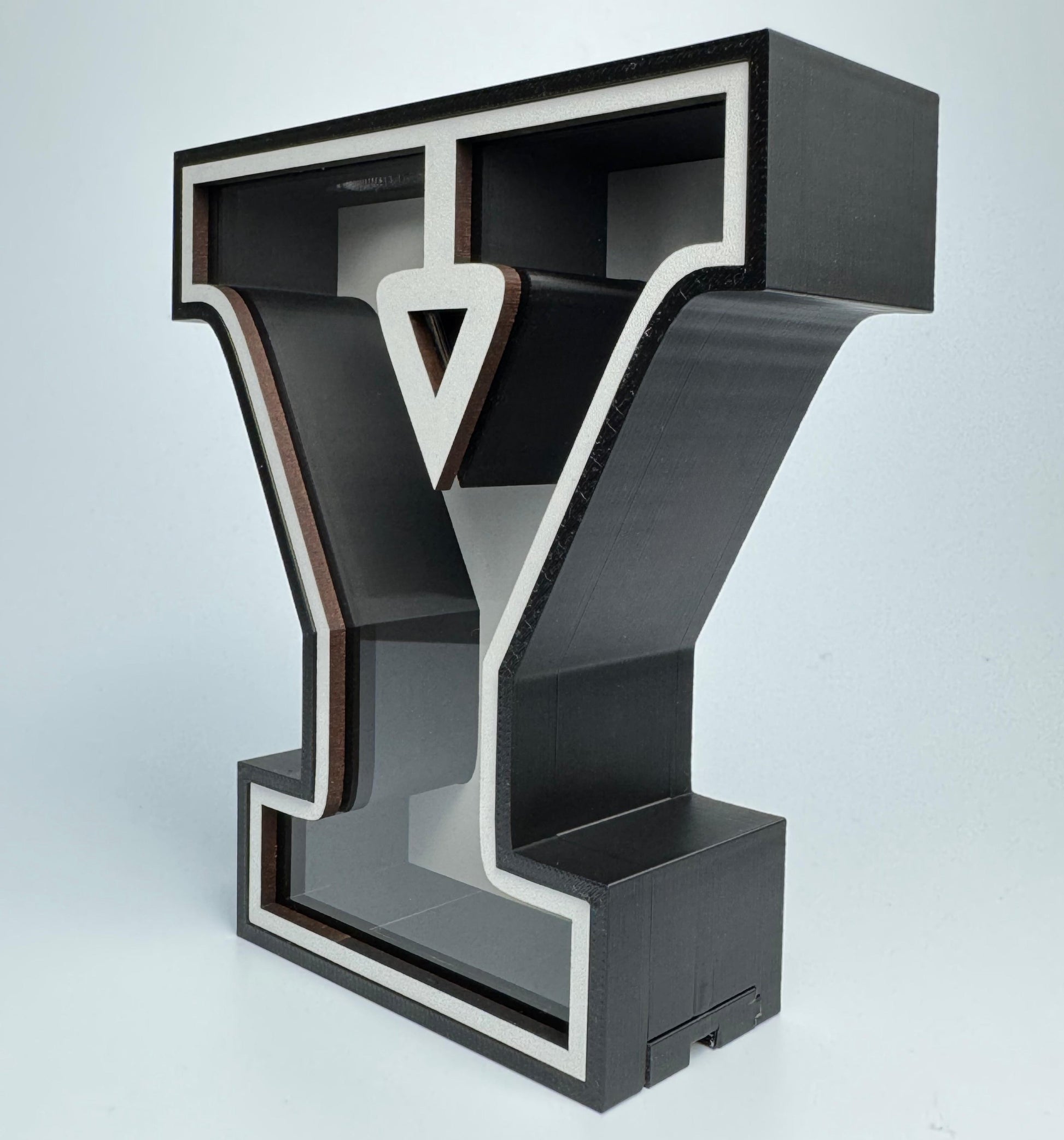 Modern bookshelf designed like a stylized letter 'Y' on a light gray background