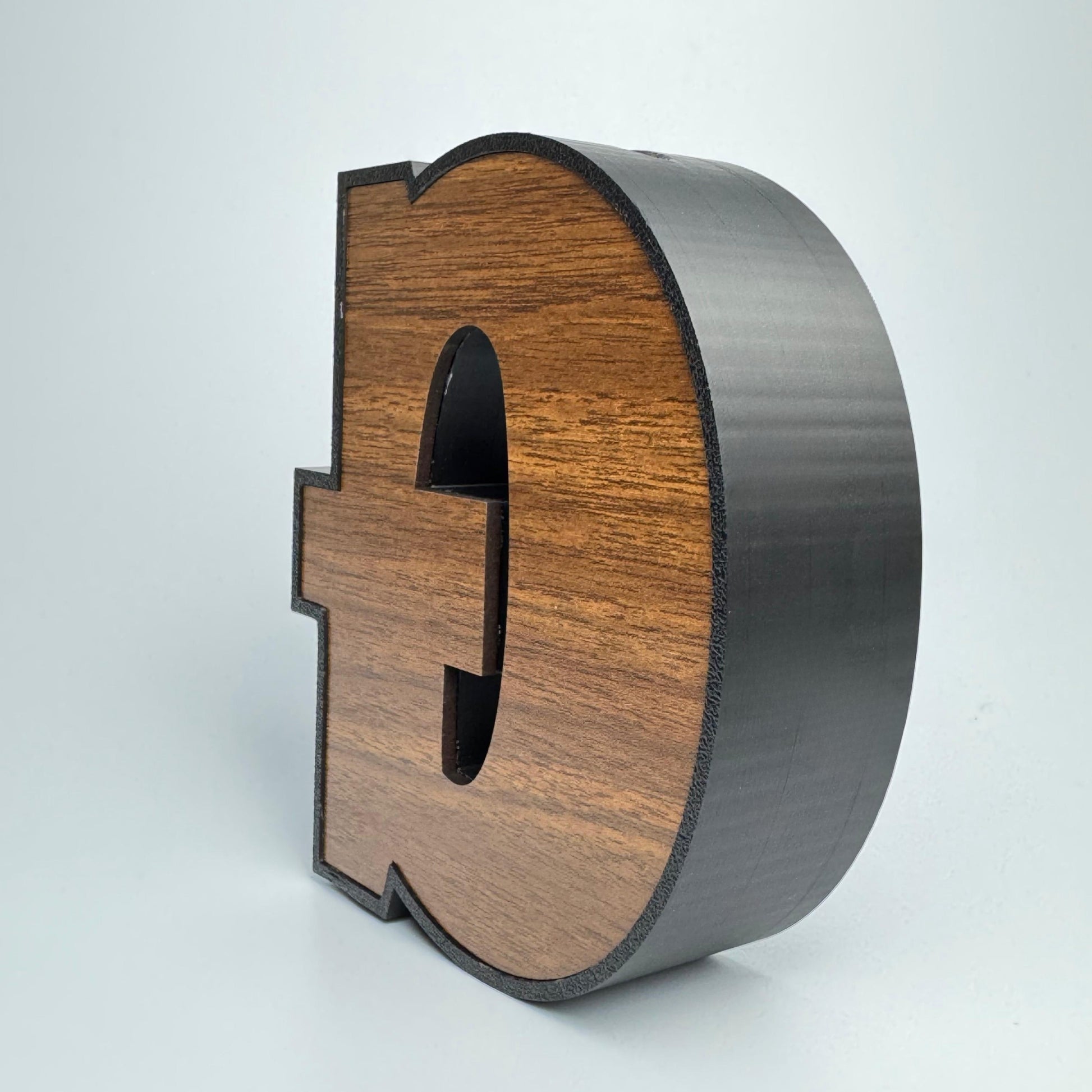 Wooden letter 'Q' on a white background