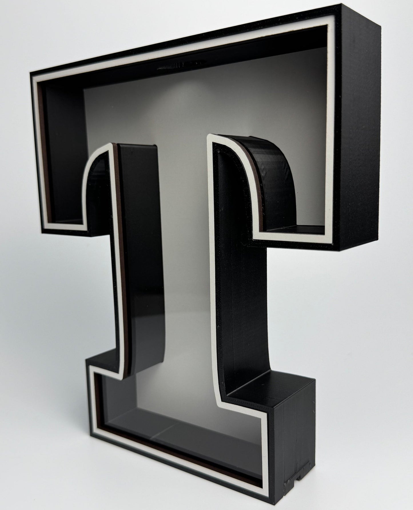 Black letter 'T' on a white background