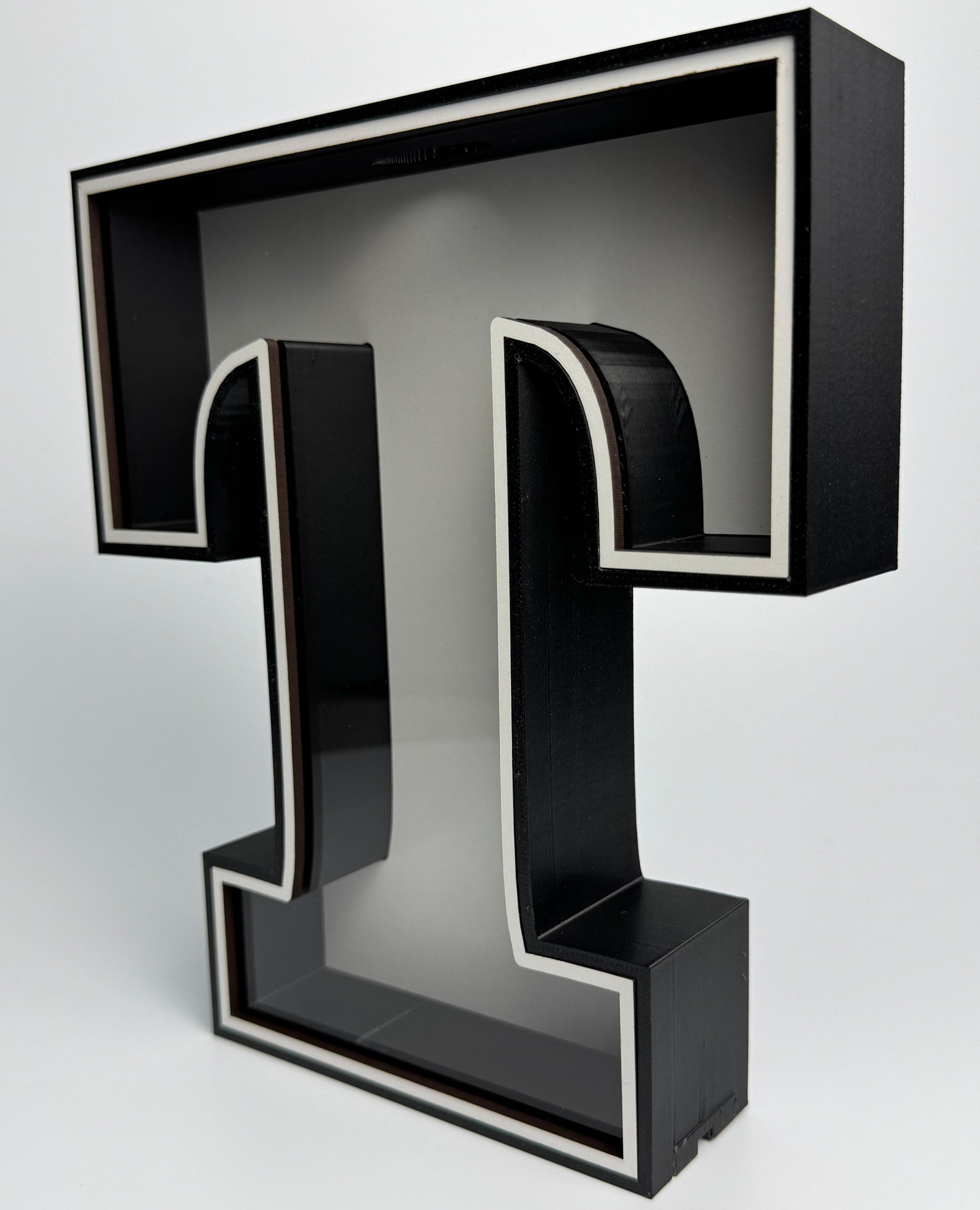 Black letter 'T' on a white background
