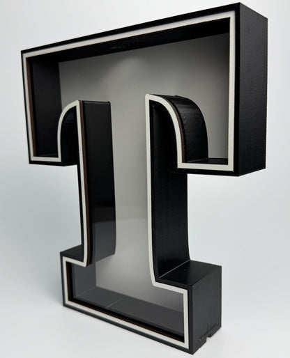 Black letter 'T' on a white background
