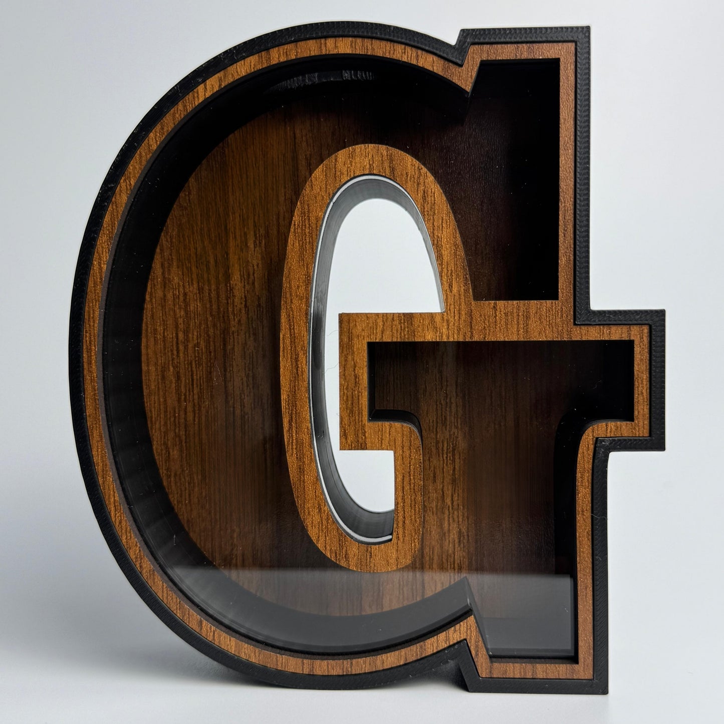 Wooden letter 'G' on a white background