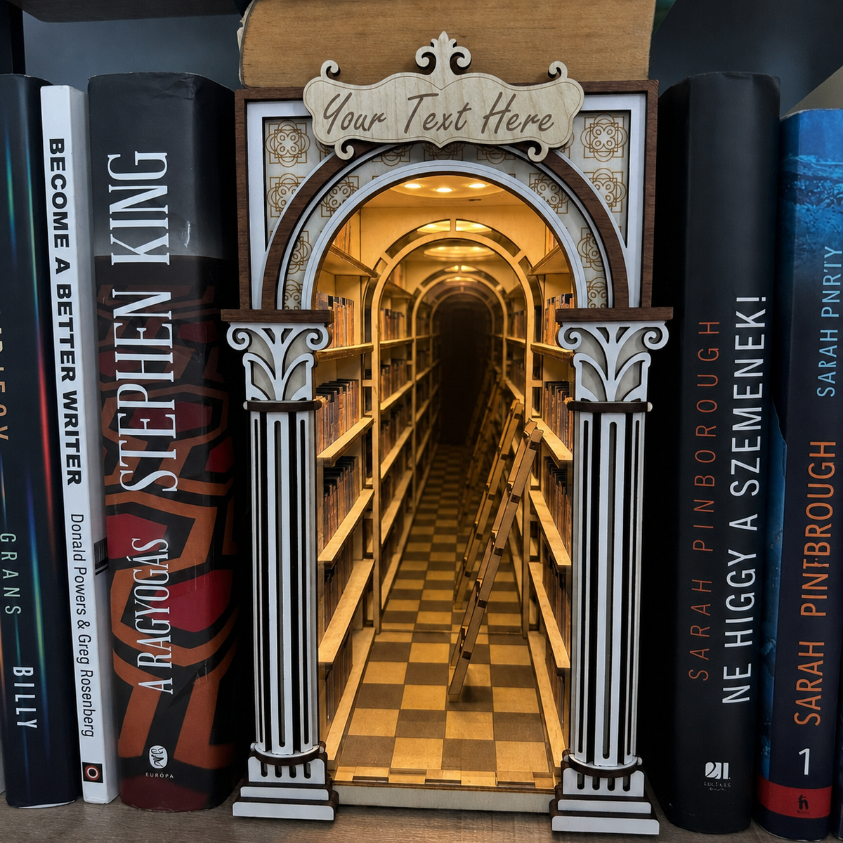 Decorative bookend with archway design resembling a library, surrounded by books.