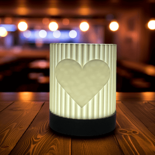 Decorative lamp with heart design on a wooden surface with a blurred background