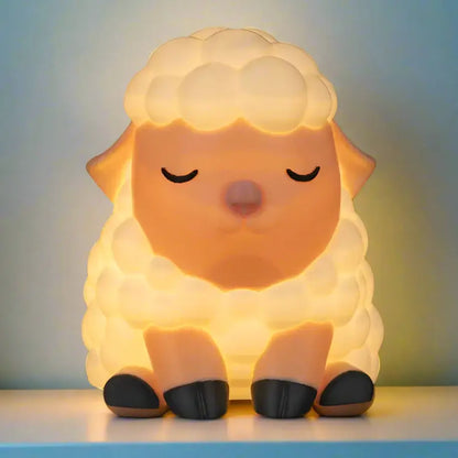 Sheep-shaped night light on a plain background