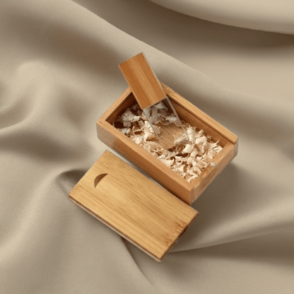 The USB drive resting on a soft fabric background, emphasising its premium materials and smooth finish.