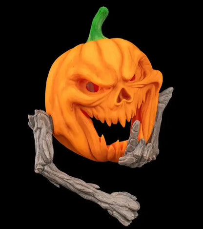 Halloween pumpkin with a carved face and skeleton hands on a black background