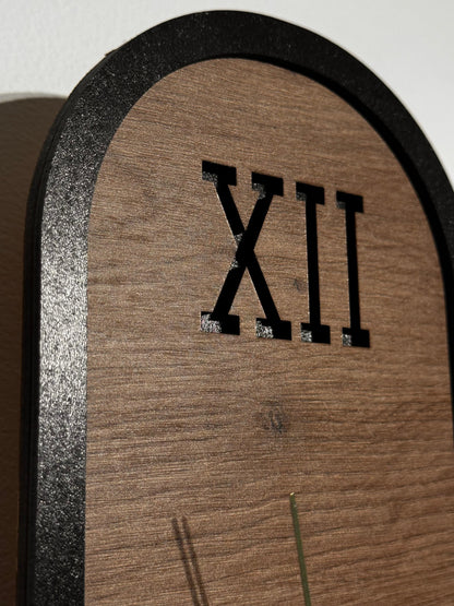 The clock mounted on a living room wall, blending seamlessly with modern decor and adding warmth with its cherry wood finish.