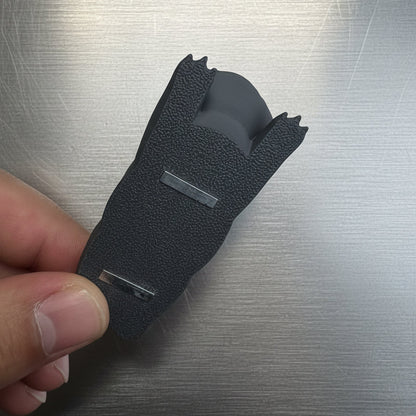 Black textured glove on a metallic surface