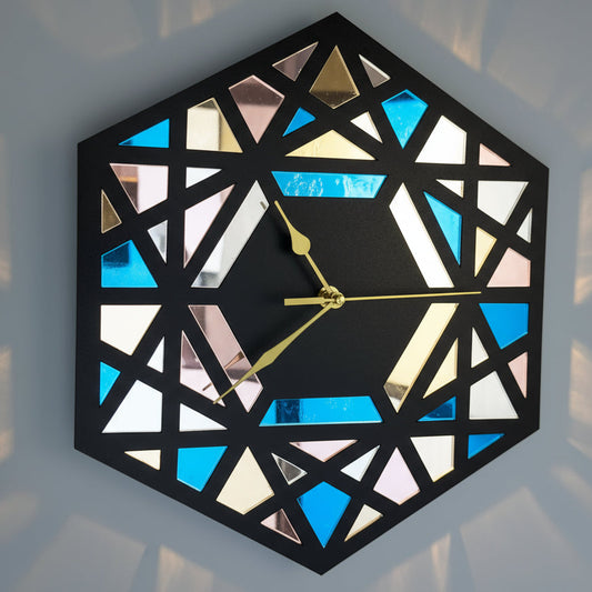 Geometric wall clock with colorful mirror-like surface on a gray background