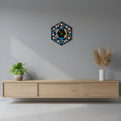 Geometric wall clock on a gray wall above a wooden console table with decorative plants.