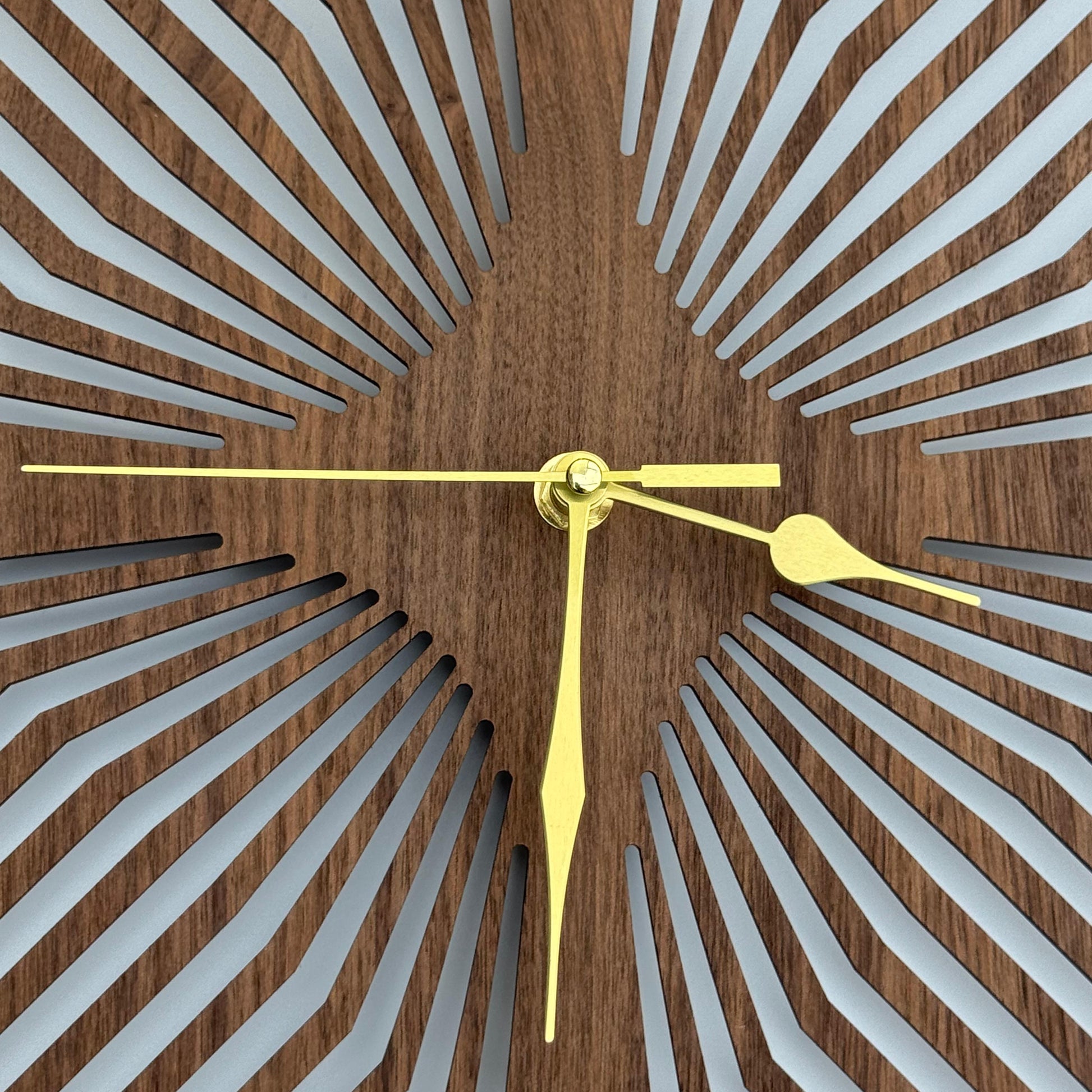 Wooden wall clock with geometric design and gold hands