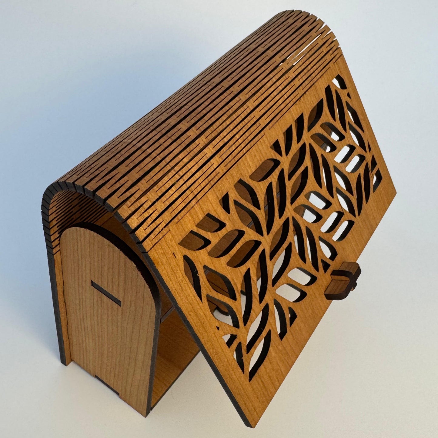 Wooden bookend with laser-cut design on a white background