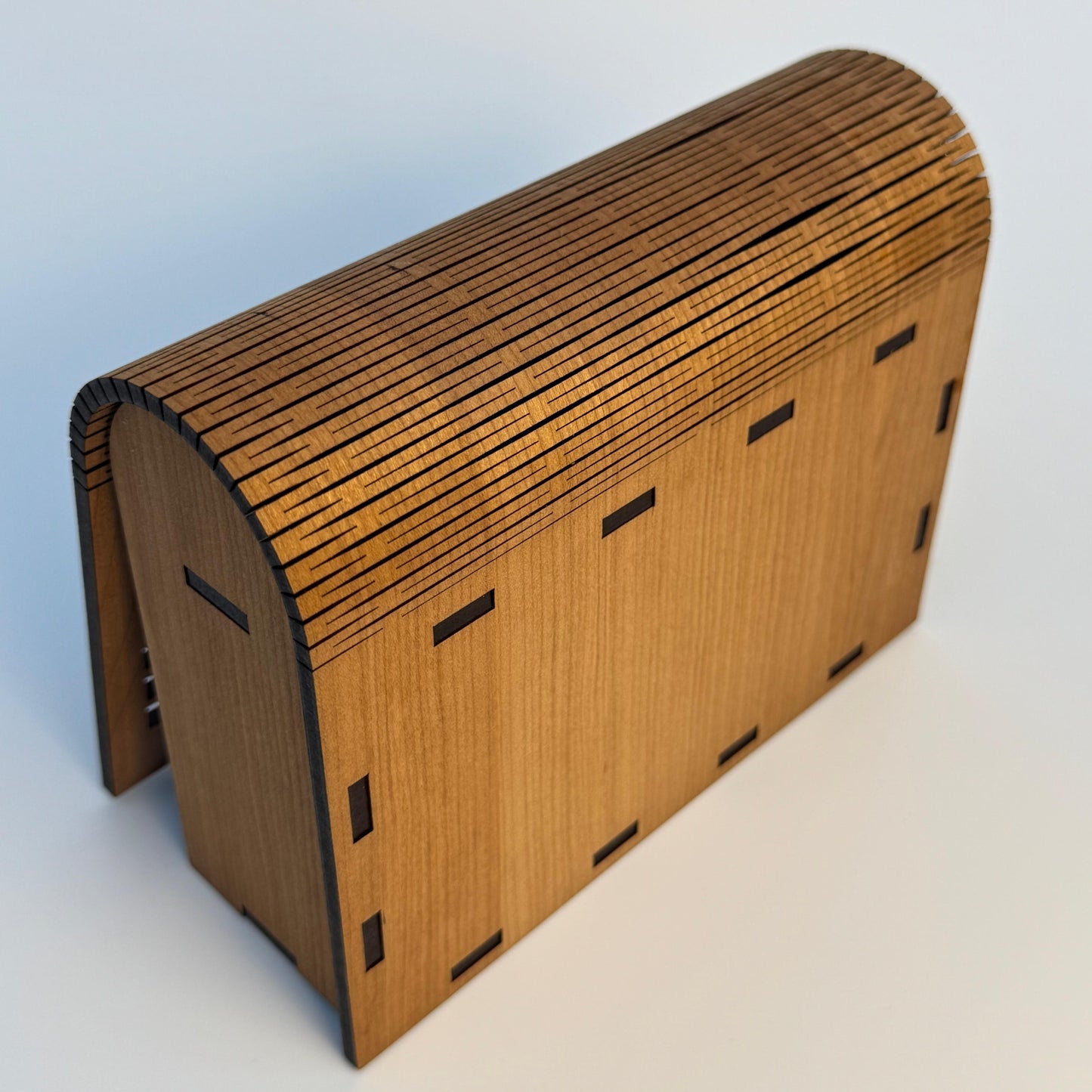 Wooden model of a barn on a light gray background