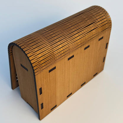 Wooden model of a barn on a light gray background