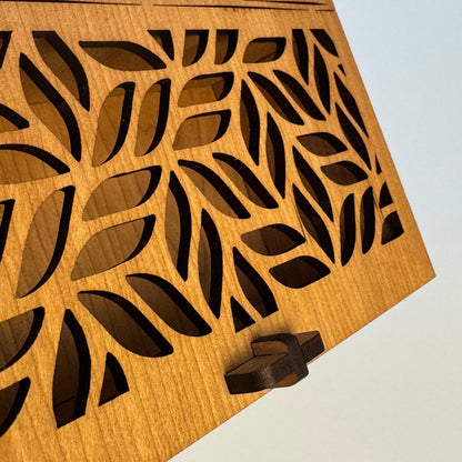 Wooden box with leaf pattern on a white background