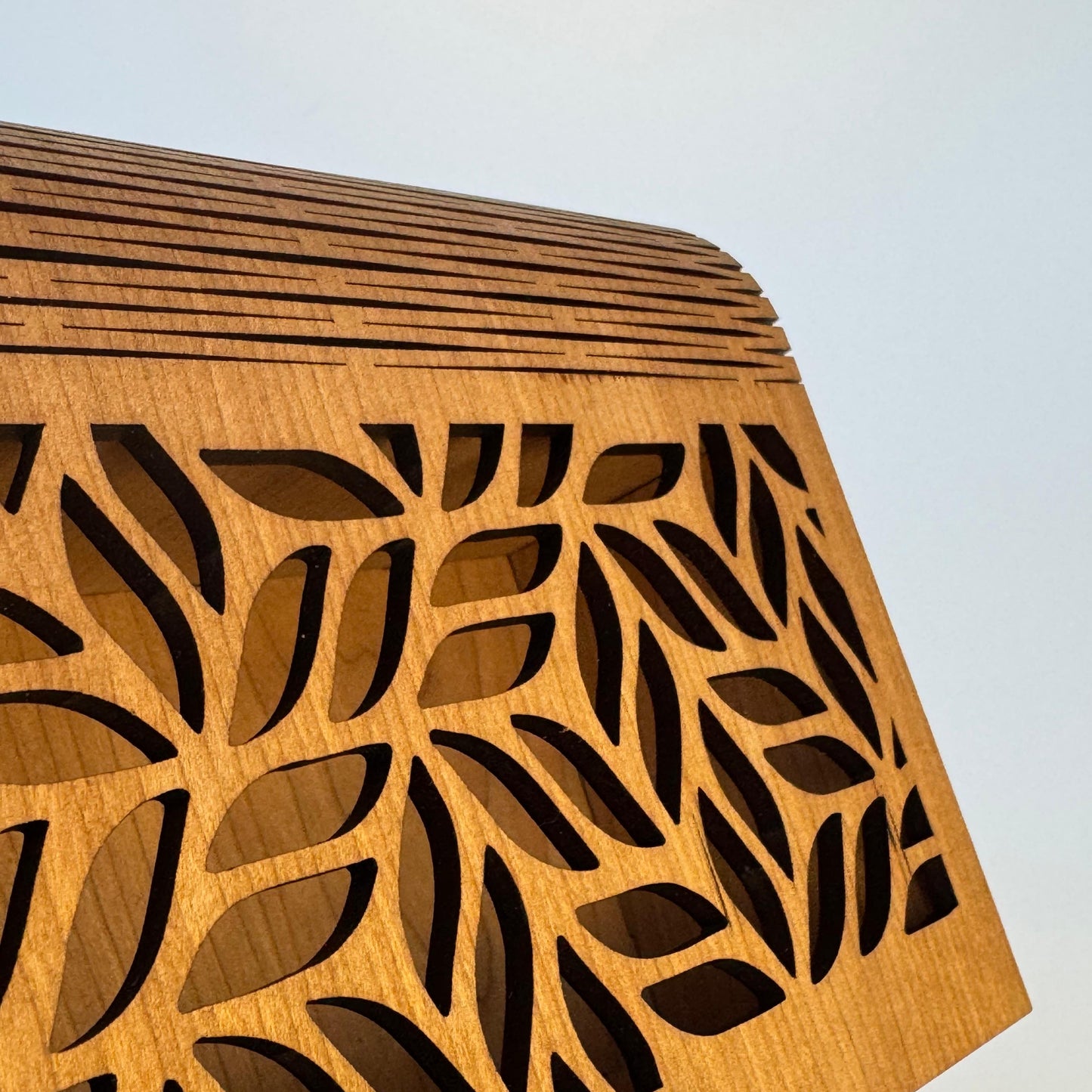 Wooden box with leaf pattern on a white background