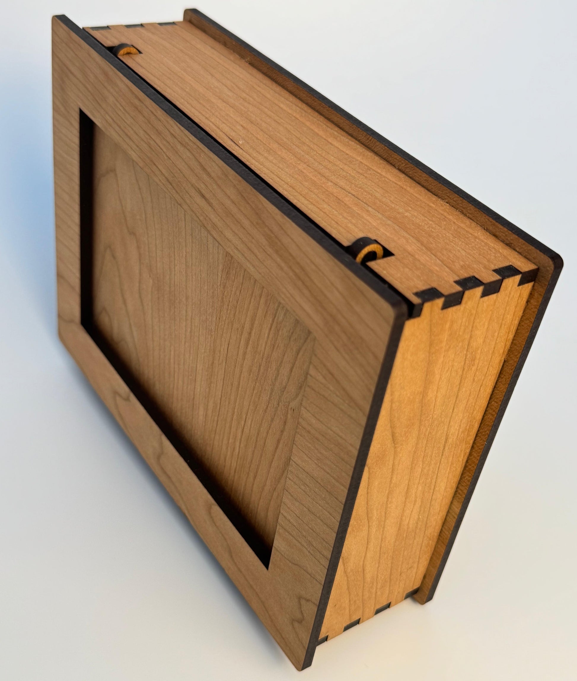 Wooden box with a hinged lid on a white background