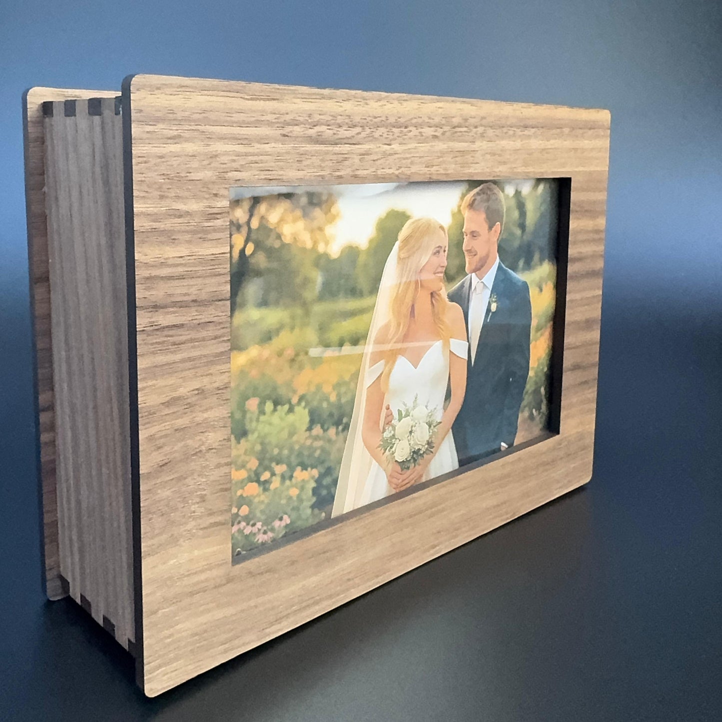 Wooden photo album with a picture of a couple on a blue background