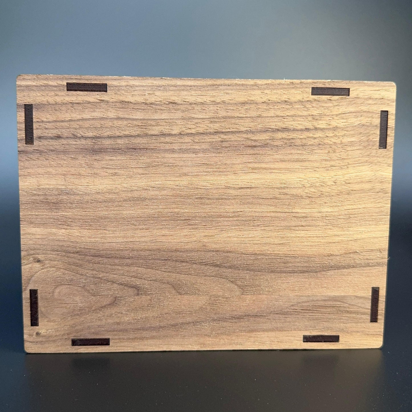 Wooden cutting board with a wenge pattern on a dark background