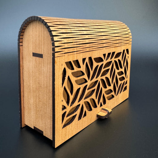 Wooden box with laser-cut design on a gradient background