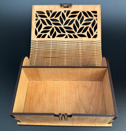 Wooden box with laser-cut lid on a dark blue background