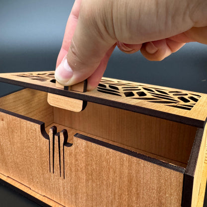 Wooden box with intricate cut-out designs on a dark background