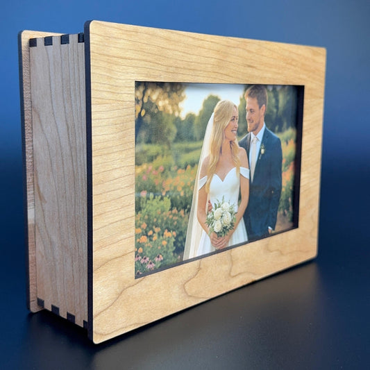 Wooden photo album with a screen displaying a wedding photo on a blue background
