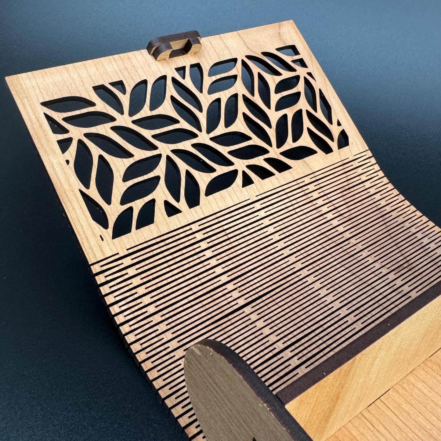 Wooden doormat with geometric leaf pattern on a blue floor