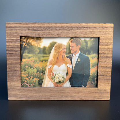 Wooden photo frame with a wedding couple inside on a dark background