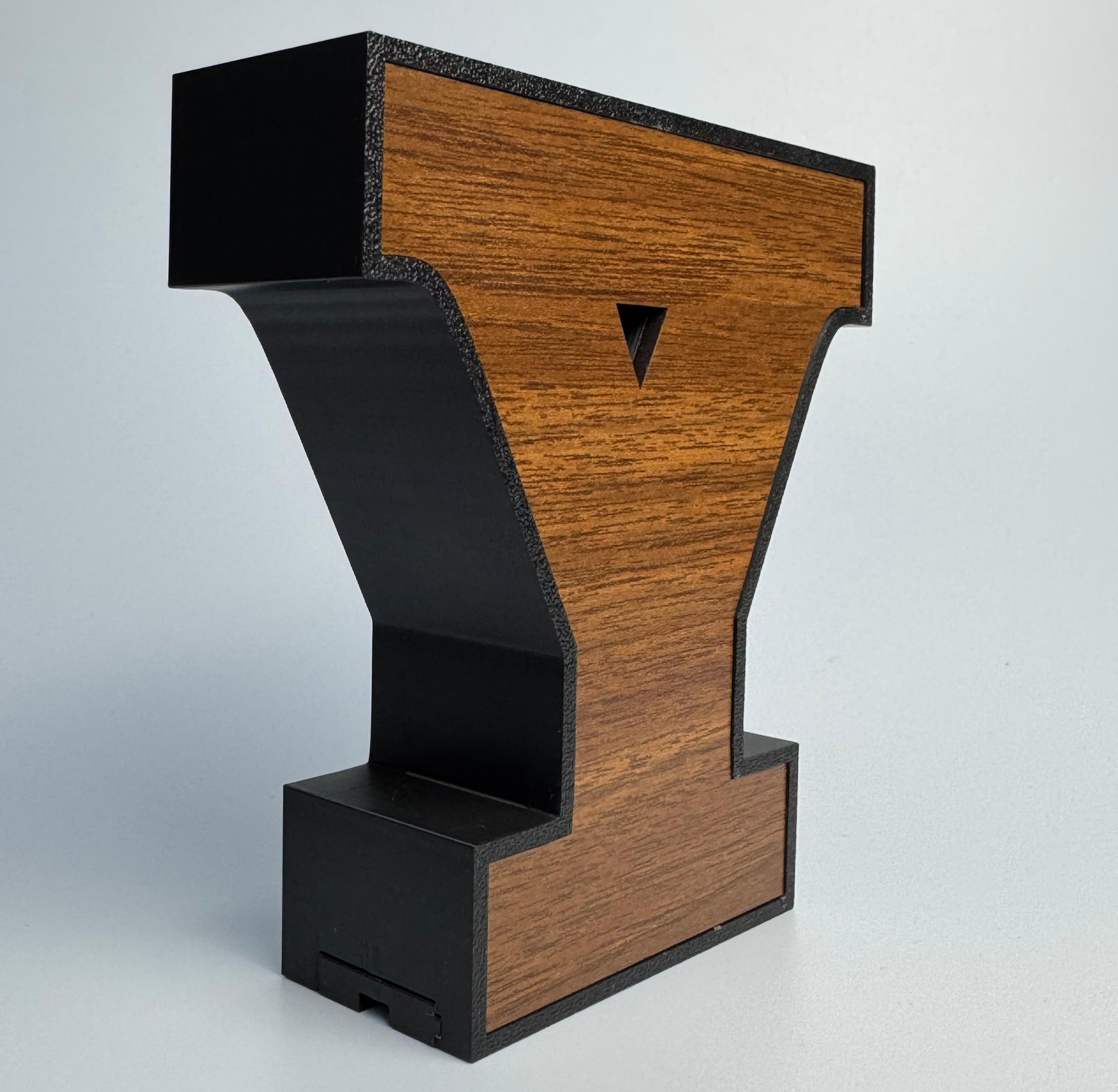 Wooden and black arcade cabinet on a light gray background