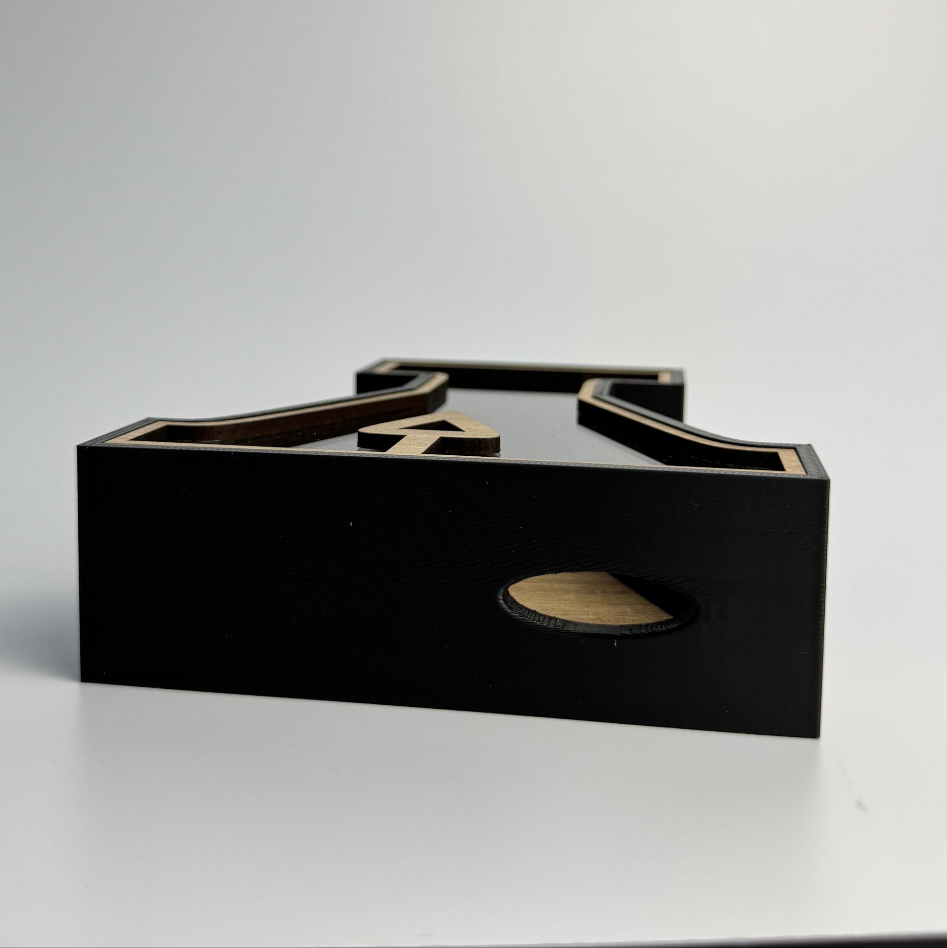 Black and gold jewelry display stand on a white background