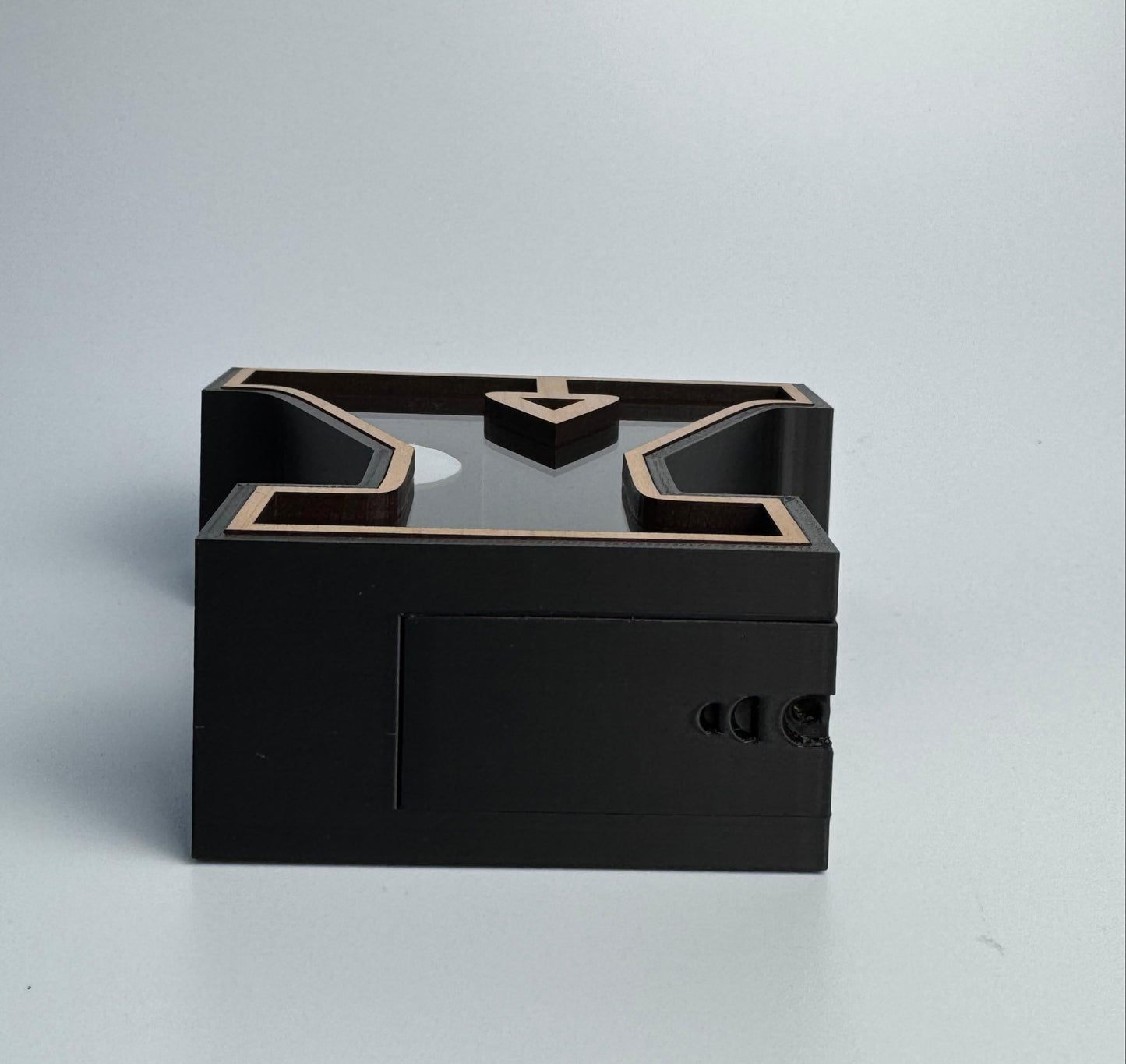 Black rectangular box with geometric design on a light gray background