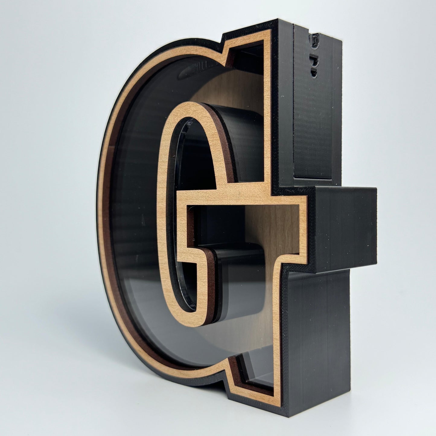 3D metal letter 'G' on a white background