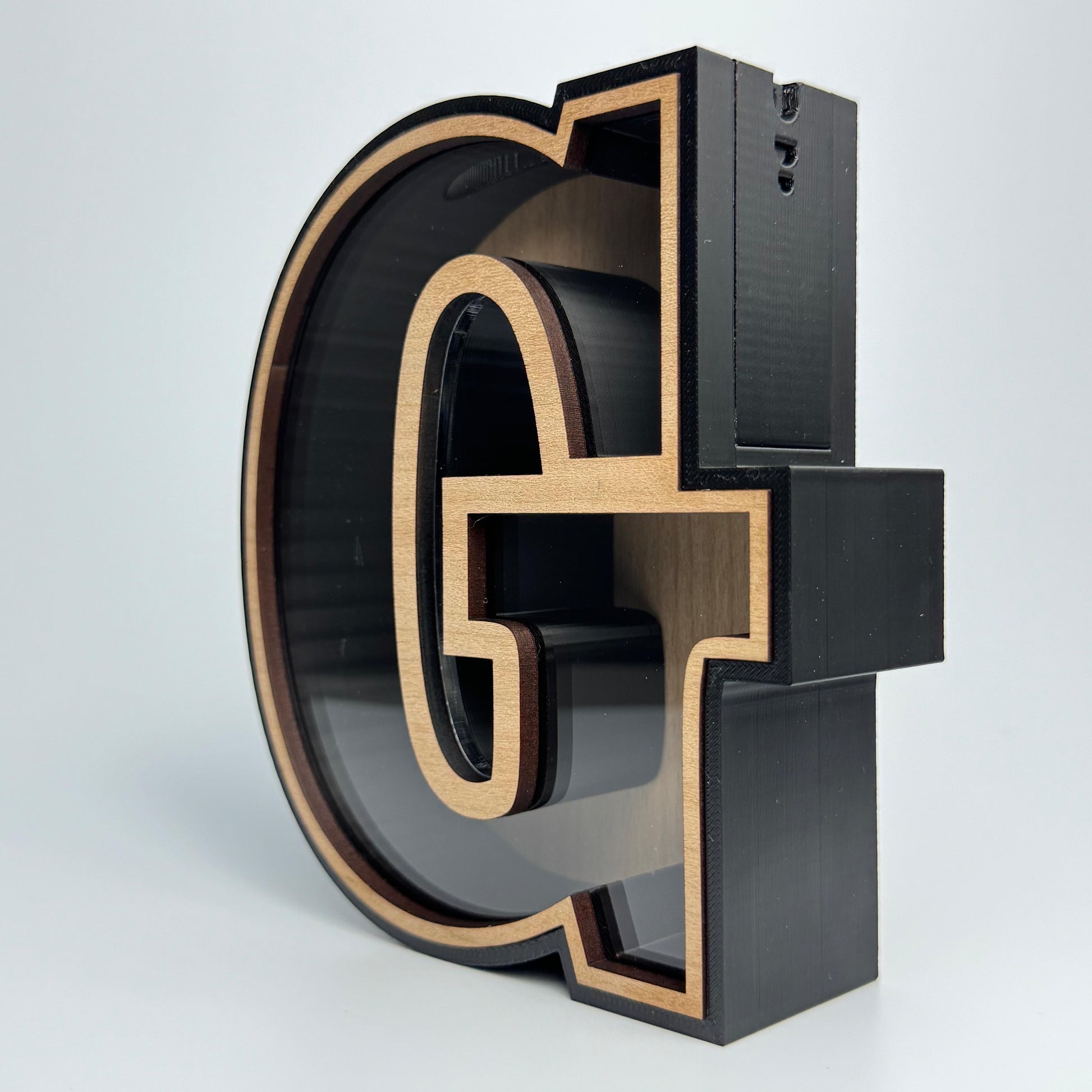3D metal letter 'G' on a white background