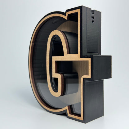 3D metal letter 'G' on a white background