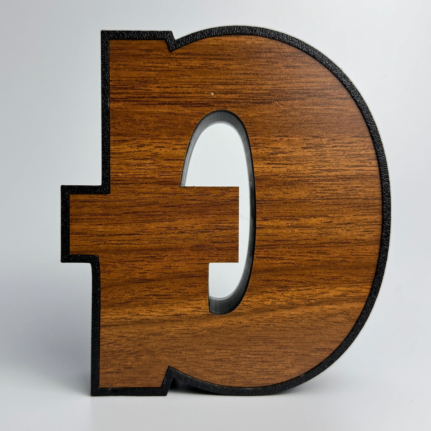 Wooden letter 'D' on a white background